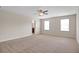 Spacious main bedroom featuring a ceiling fan, carpet, and natural light at 16016 Persimmon Grove Dr, Lithia, FL 33547