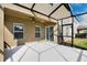 Screened patio with ceiling fan overlooks the backyard at 16016 Persimmon Grove Dr, Lithia, FL 33547