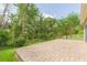 Spacious backyard featuring a brick patio, lush green grass, a chain link fence and shade trees at 20403 Sultana Ct, Tampa, FL 33647