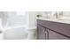 Bathroom features a tub and updated vanity with dark wood cabinets at 20403 Sultana Ct, Tampa, FL 33647