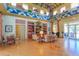 Spacious clubhouse lounge with decorative accents, tables, chairs, and doors to the pool area at 20403 Sultana Ct, Tampa, FL 33647