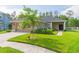 Charming single-story home featuring a manicured lawn and a welcoming front entrance at 20403 Sultana Ct, Tampa, FL 33647
