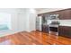 Modern kitchen featuring stainless steel appliances, dark wood cabinets, and shiny hardwood floors at 20403 Sultana Ct, Tampa, FL 33647
