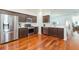 Bright kitchen with stainless steel appliances, dark cabinets, hardwood floors, and open floor plan at 20403 Sultana Ct, Tampa, FL 33647