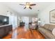 Open-concept living area with a ceiling fan, lots of light, and wood-style floors at 20403 Sultana Ct, Tampa, FL 33647