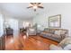 Expansive living room with hardwood flooring, neutral tones, and a ceiling fan at 20403 Sultana Ct, Tampa, FL 33647