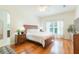Bright main bedroom with hardwood floors, ceiling fan, and large window for natural light at 20403 Sultana Ct, Tampa, FL 33647