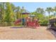 Playground area featuring slides, climbing structure, and wood chip ground cover on a sunny day at 20403 Sultana Ct, Tampa, FL 33647