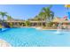 Community pool featuring a splash fountain, lounge seating, tropical landscaping, and a clubhouse at 20403 Sultana Ct, Tampa, FL 33647