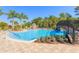 Spacious community pool with a gradual entry, bridge, splash pad, and lounge seating at 20403 Sultana Ct, Tampa, FL 33647
