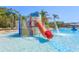 View of the waterpark with a slide and fountains in the community pool area on a sunny day at 20403 Sultana Ct, Tampa, FL 33647