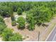 Sprawling home nestled amongst mature trees with a long driveway on a large lot near a road at 2205 Henley Rd, Lutz, FL 33558