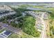 Distant aerial view of a home surrounded by a canopy of mature trees near homes and ponds at 2205 Henley Rd, Lutz, FL 33558