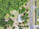 Aerial view of a home on a large treed lot close to a road and newer construction at 2205 Henley Rd, Lutz, FL 33558