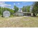 Backyard featuring a shed, pergola, and a covered parking area attached to the house at 2205 Henley Rd, Lutz, FL 33558