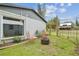 Inviting backyard space with a fire pit, seating, garden, and lush green surroundings creating a relaxing atmosphere at 2205 Henley Rd, Lutz, FL 33558