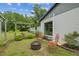 Charming backyard with a fire pit, seating area, and landscaping providing a relaxing outdoor retreat at 2205 Henley Rd, Lutz, FL 33558