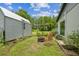 Cozy backyard featuring a fire pit, outdoor seating, and beautifully landscaped garden beds, perfect for entertaining at 2205 Henley Rd, Lutz, FL 33558