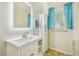Bathroom featuring a modern vanity, mirror, and shower with blue curtains at 2205 Henley Rd, Lutz, FL 33558