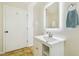 Bright bathroom with a modern vanity, illuminated mirror, and neutral tile flooring at 2205 Henley Rd, Lutz, FL 33558