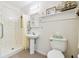 Bathroom featuring a shower, pedestal sink, toilet, and a mirrored medicine cabinet at 2205 Henley Rd, Lutz, FL 33558