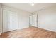 Bright bedroom features wood-look floors, a closet, and neutral wall paint at 2205 Henley Rd, Lutz, FL 33558
