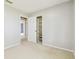 Neutral bedroom features plush carpeting and closet, ready for personalization at 2205 Henley Rd, Lutz, FL 33558