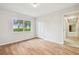 Inviting bedroom featuring natural light, wood-look floors, and a spacious closet at 2205 Henley Rd, Lutz, FL 33558