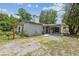 View of the side and back of the house featuring a covered patio and an ornate pergola at 2205 Henley Rd, Lutz, FL 33558