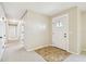 Hallway featuring carpet flooring, neutral walls, and a decorative front door with glass inserts at 2205 Henley Rd, Lutz, FL 33558