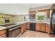 Kitchen with an oven and cooktop, along with wood cabinets and tile flooring at 2205 Henley Rd, Lutz, FL 33558