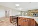Kitchen with island cooktop, tile floor, wood cabinets and view to backyard at 2205 Henley Rd, Lutz, FL 33558