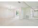 Spacious living room featuring neutral paint, carpet and contemporary light fixture at 2205 Henley Rd, Lutz, FL 33558