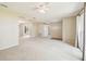 Bright living area with large windows, neutral walls, and access to various parts of the house at 2205 Henley Rd, Lutz, FL 33558