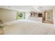 Open-concept living room and kitchen area featuring neutral tones, and sliding doors leading to the outside at 2205 Henley Rd, Lutz, FL 33558