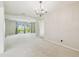 Expansive living area with plush carpeting and natural light, open to dining and entryway at 2205 Henley Rd, Lutz, FL 33558