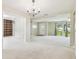 Bright, open-concept living space featuring carpet, neutral walls, and natural light at 2205 Henley Rd, Lutz, FL 33558