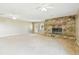 Spacious living room with a stone fireplace, ceiling fans, and access to the exterior and a cozy atmosphere at 2205 Henley Rd, Lutz, FL 33558