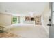 Spacious living room area connected to kitchen with access to backyard at 2205 Henley Rd, Lutz, FL 33558