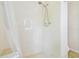 Bright, tiled shower stall with handheld shower head and neutral color scheme at 2205 Henley Rd, Lutz, FL 33558