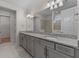Bathroom featuring double sinks with granite countertops and stylish gray cabinetry at 2280 Long Spur, Odessa, FL 33556