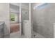 Modern bathroom featuring a tiled shower and an open doorway into the bedroom at 2280 Long Spur, Odessa, FL 33556