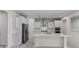 Modern kitchen with white cabinets, stainless steel appliances, and large center island at 2280 Long Spur, Odessa, FL 33556