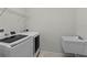 Laundry room with a washing machine, a sink, and wire shelving at 2280 Long Spur, Odessa, FL 33556