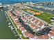 Beautiful aerial view of a waterfront community with boat docks and easy beach access at 230 Medallion Blvd # F, Madeira Beach, FL 33708