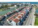 A long stretch of waterfront condos are captured from above, lined with boat slips and a neighborhood recreation space at 230 Medallion Blvd # F, Madeira Beach, FL 33708