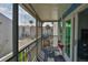 Screened in balcony with seating and views of the neighborhood at 230 Medallion Blvd # F, Madeira Beach, FL 33708