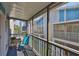 Relaxing balcony featuring a chair and table with greenery, and neighborhood views at 230 Medallion Blvd # F, Madeira Beach, FL 33708
