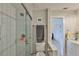 Bathroom featuring a walk-in shower with grey and white subway tiles at 230 Medallion Blvd # F, Madeira Beach, FL 33708
