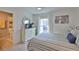 Bright bedroom with striped bedding, white curtains, and natural light at 230 Medallion Blvd # F, Madeira Beach, FL 33708